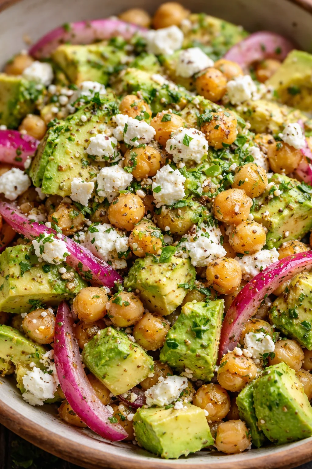 Kichererbsen-Feta-Avocado-Salat in einer Schüssel dekoriert mit frischen Kräutern